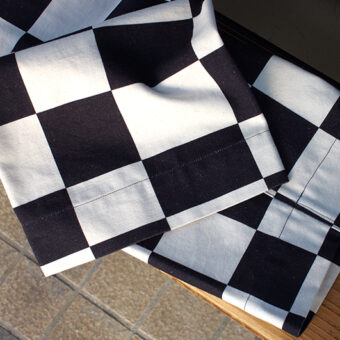 IRREGULAR CHECKERED FLAG WIDE TROUSERS